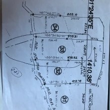 A hand-drawn survey map of numbered land lots with boundary measurements
